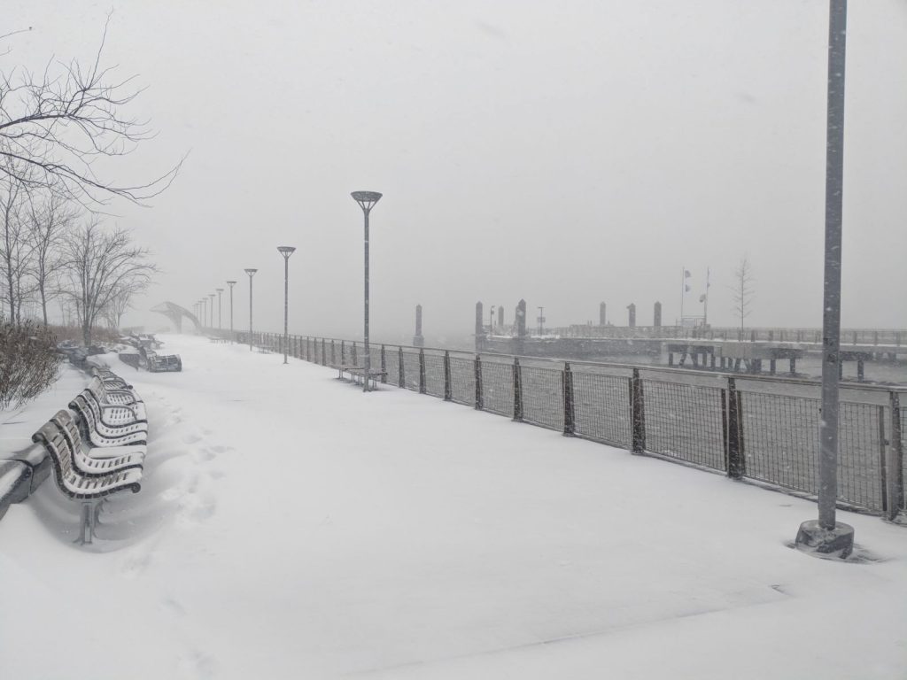 A pier and benches covered in snow after a snowstorm in New York